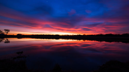 Scenic view of lake at sunset