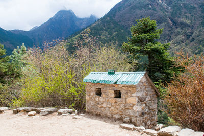 Built structure on landscape against mountain range