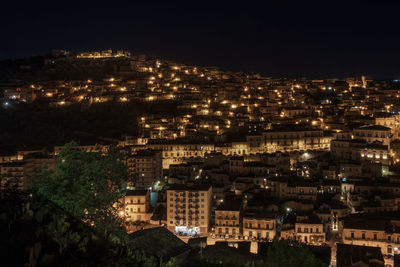 High angle view of illuminated buildings in city at night