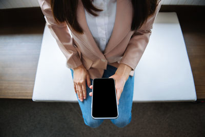 Top view, woman is working with smart phones.