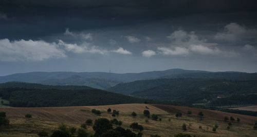 Scenic view of mountains against cloudy sky