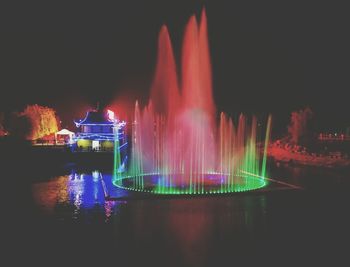 Illuminated fountain at night