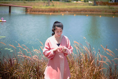 Full length of woman standing in water