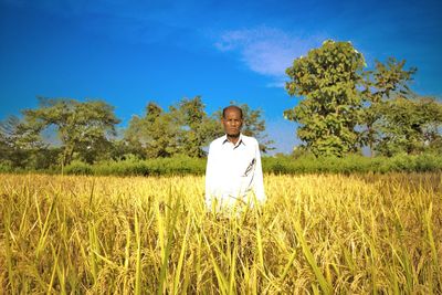 Man standing in field against clear sky