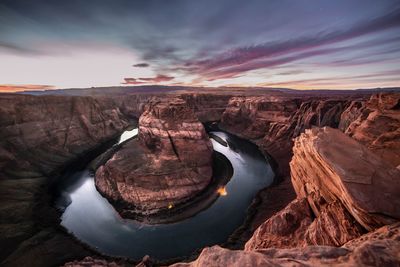 Aerial view of rock formations against sky during sunset