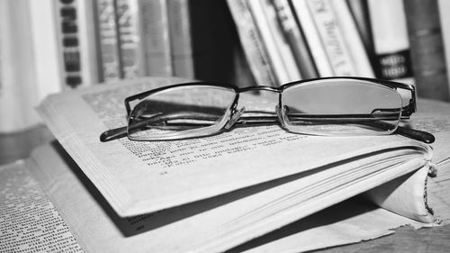 Close-up of eyeglasses on book at table