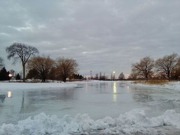 Frozen lake against sky during winter