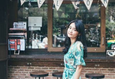 Portrait of beautiful young woman standing outdoors