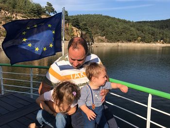 Father with children sitting in boat