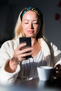 Mid adult woman using mobile phone
