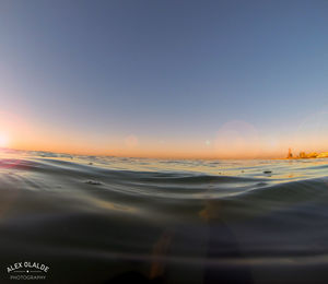 Scenic view of sea against clear sky during sunset