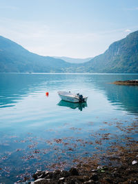 Nautical vessel in lake against sky