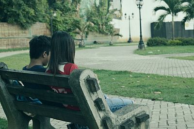 Rear view of woman sitting outdoors