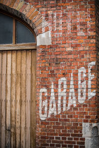 Close-up of text on brick wall