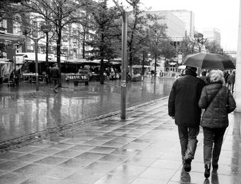 Man walking on wet street in rainy season