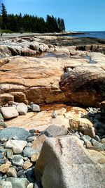 Rocks in sea against clear sky