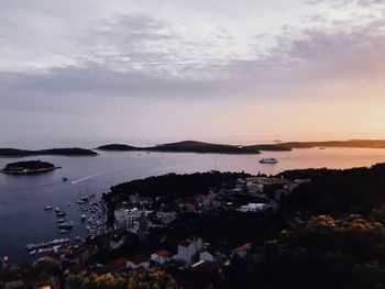 High angle view of bay against sky at sunset