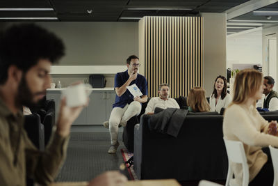 Group of business people having meeting in lobby