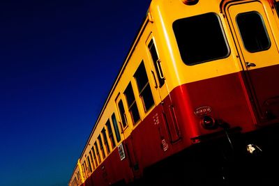 Low angle view of yellow wheel against sky