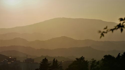 Scenic view of silhouette mountains against sky during sunset