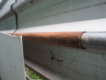 High angle view of pipe on railing