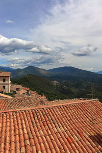 High angle view of houses on mountain against sky