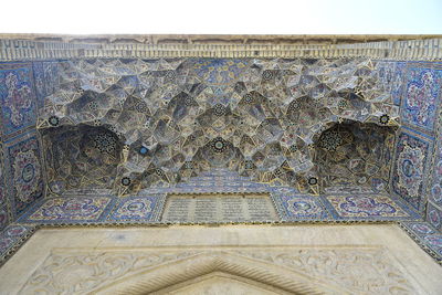 Low angle view of carving on wall of building