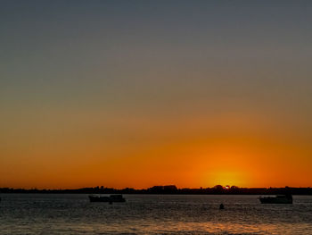 Scenic view of sea against orange sky