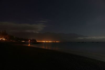 Scenic view of beach against sky at night