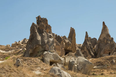 Rock formations on landscape against clear sky