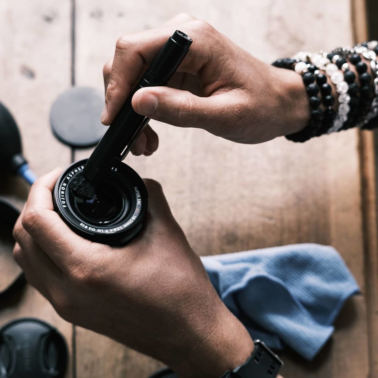 MIDSECTION OF MAN PHOTOGRAPHING WITH CAMERA