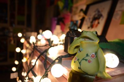 Close-up of illuminated candles on table