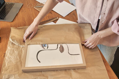 High angle view of man painting on table