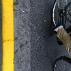 Low section of man standing on road