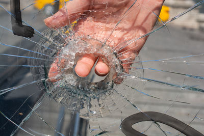 Close-up of hand holding glass of water