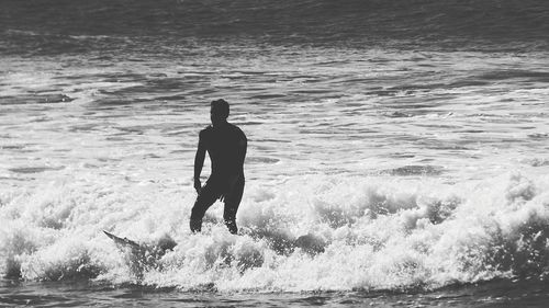 Full length of man surfing in sea