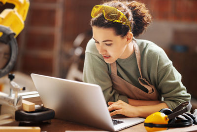 Young woman using laptop at home