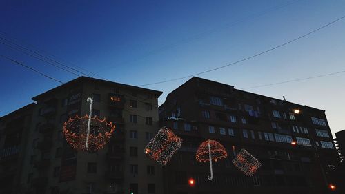 Low angle view of illuminated building against clear sky