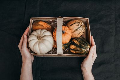 Cropped hands of woman holding pumpkin