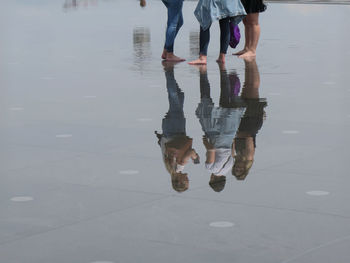 Low section of people walking on water