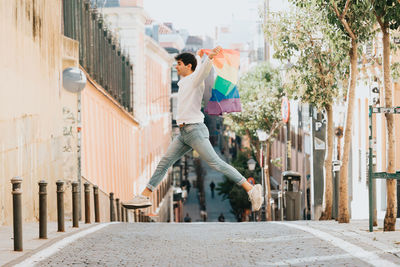 Full length of man jumping over road