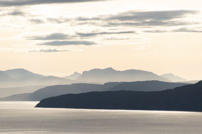 Scenic view of silhouette mountains against sky during sunset