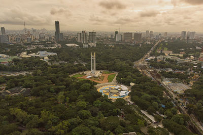 High angle view of buildings and trees against sky