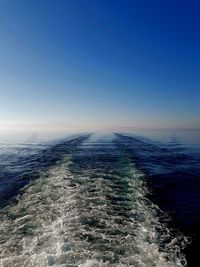 Scenic view of sea against clear blue sky