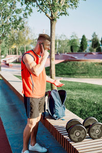 Midsection of man holding umbrella