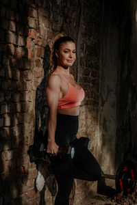 Portrait of woman while standing in abandoned building