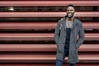 Portrait of laughing young man standing outdoors