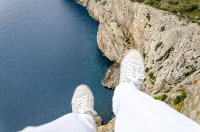 Low section of man standing on tiled floor