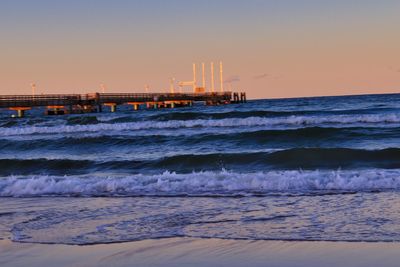 Scenic view of sea against clear sky during sunset