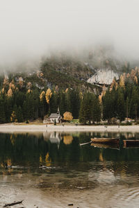 Scenic view of lake by trees against sky